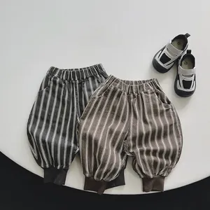Close-up of kids' striped cotton trousers with elastic waist and gathered cuffs