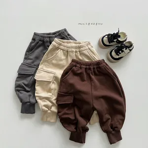 Detailed view of cargo joggers for kids in dark grey, beige, and brown with side pockets