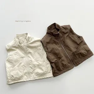 Flat lay of unisex children's cargo vests in beige and tan with fleece lining