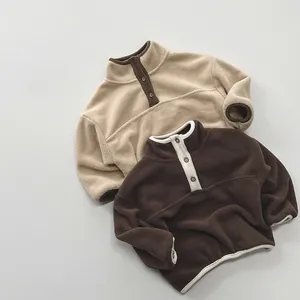 Detail of soft fleece kid's pullover with half-button collar and contrast binding