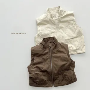 Detailed flat lay of cream and dark brown kids' utility vests with four front pockets