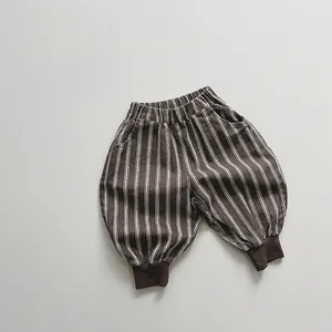 Detail view of boys' striped cotton jogger pants with elastic waist and ribbed cuffs