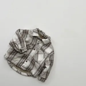 Detailed view of kids vintage plaid shirt with warm yellow fleece lining and wood buttons