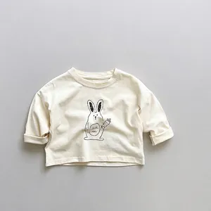 Close-up of kids cream long sleeve t-shirt with minimalist black line rabbit graphic