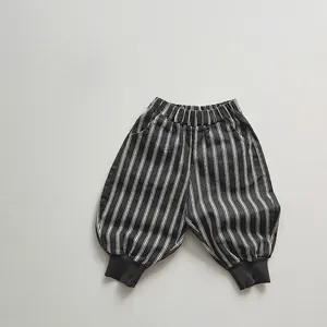 Close-up of boys' striped cotton trousers showing elastic waistband and fabric texture