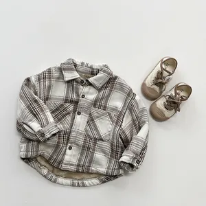 Detail of kids brown plaid fleece lined shirt with single pocket and button closure