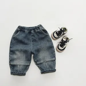 Detail view of children's fleece-lined denim pants with elastic waist and retro wash blue