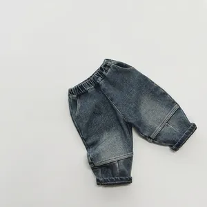 Detail of kids vintage blue fleece lined jeans with elastic waist and segmented stitching