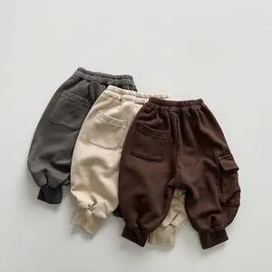 Detailed view of three-color children cargo joggers with elastic waist and ribbed cuffs