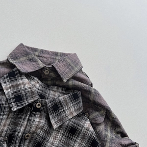 Detailed view of kids vintage plaid shirts with cotton linen texture and retro buttons