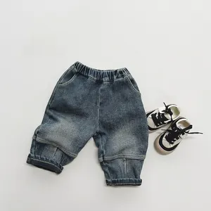 Detailed flat lay of boys' fleece-lined dark blue denim jeans with an elastic waistband