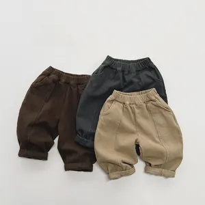 Detail view of elastic waist and rolled cuffs on three colors of kids fleece pants