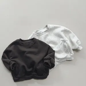 Detail of ribbed cuffs and side pockets on casual fleece sweatshirts for kids