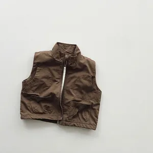 Detail of kids cargo vest featuring stand collar zipper and large symmetric pockets