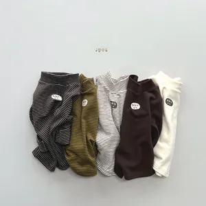 Flat lay of five assorted ribbed thermal shirts for kids with striped and solid patterns