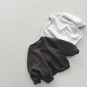 Close-up of fleece sweatshirts in light and dark grey with side pockets and ribbed cuffs