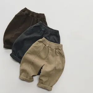 Detail view of winter fleece pants for kids in brown, charcoal grey and khaki colors