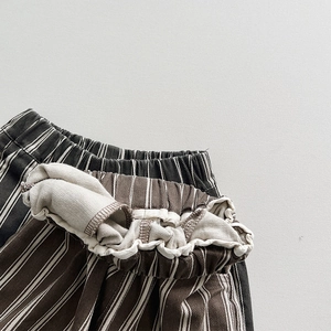 Boys striped cotton trousers featuring elastic waist and casual loose fit in brown and black