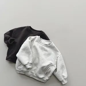 Detail view of fleece sweatshirts showing ribbed cuffs and pockets in brown and grey