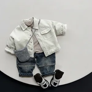 Winter kids vintage blue washed denim jeans styled with a fleece jacket and accessories