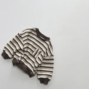 Detail view of children's fleece striped sweater with ribbed cuffs and pocket texture