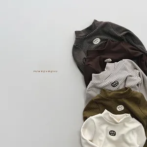 Detail showing five fleece-lined children's tops in solid colors and striped patterns