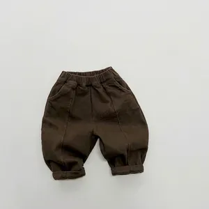 Detailed flat lay of children's cotton fleece pants in dark brown with elastic waistband