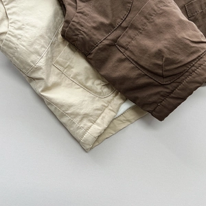 Detailed close-up of durable cargo vest pockets and reinforced double stitching