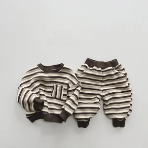 Flat lay of brown and beige striped kids sweatshirt and matching jogger set details