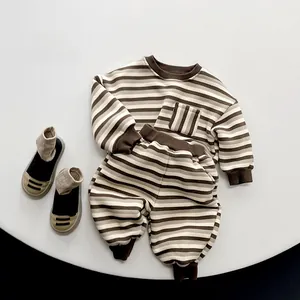 Close-up of baby striped long-sleeved top showing soft cotton texture and chest pocket detail