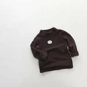 Detail of soft fleece cotton texture on kids dark brown striped long sleeve shirt