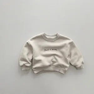 Detail of cream sweatshirt showing ribbed collar and Dad < mom print for kids