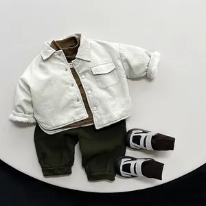 Flat lay of kids reversible corduroy fleece jacket with green turtleneck and pants set