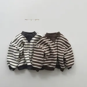 Detail of kids striped sweaters with V-stitch neckline and ribbed cuffs in winter style