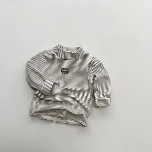 Detail of children's fleece-lined striped turtleneck with round chest print logo
