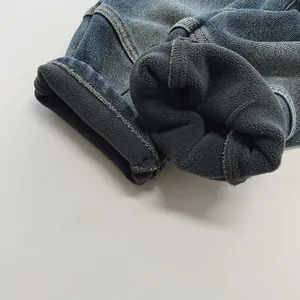 Close-up of boys thick fleece lining and durable denim fabric on winter pants
