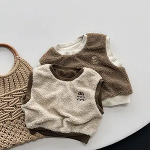 Close-up of soft fleece texture and warm vibes embroidery on children color-block vests
