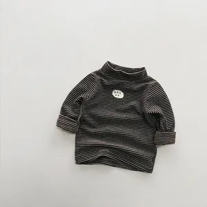 Detail view of children's fleece striped sweater showing soft fabric and chest patch