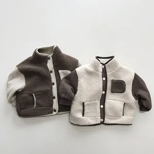 Detailed close-up of kids thickened fleece jacket with corduroy sleeves and snap buttons