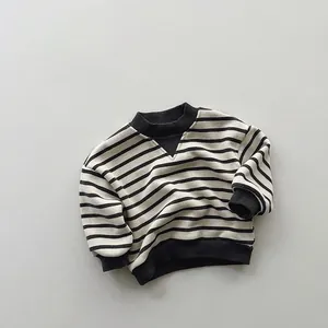 Detail of black and white striped kids sweatshirt with ribbed cuffs and V-stitch neckline
