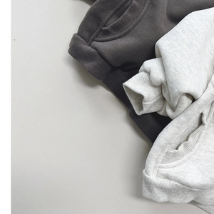 Detail of ribbed cuffs and kangaroo pockets on high-quality fleece hoodies for kids