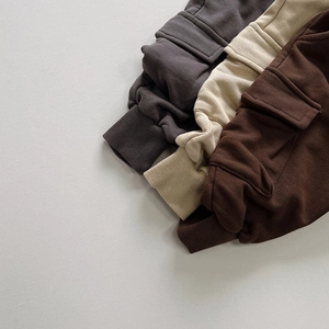 Detail of cargo pockets and ribbed cuffs on three colors of cotton toddler sweatpants