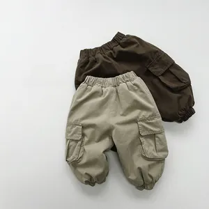 Detail of khaki and coffee cargo pants with elastic waist and large side pockets