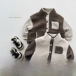 Flat lay detail of kids color-block fleece jackets and casual canvas sneakers
