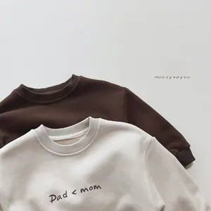 Close-up of ribbed neckline and cotton texture on printed fleece sweatshirts for kids