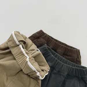 Detailed texture of corduroy fabric showing elastic waistbands in three colors