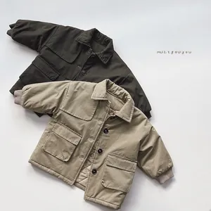 Detail of kids cotton coats in khaki and green with large cargo pockets and buttons
