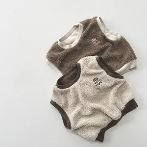 Detail of fleece vest for kids in coffee and cream with warm vibes embroidery