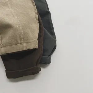 Close-up of winter fleece-lined corduroy pants for children in three earth-tone colors