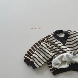Detail of warm striped children's sweatshirts with soft fleece lining and ribbed cuffs